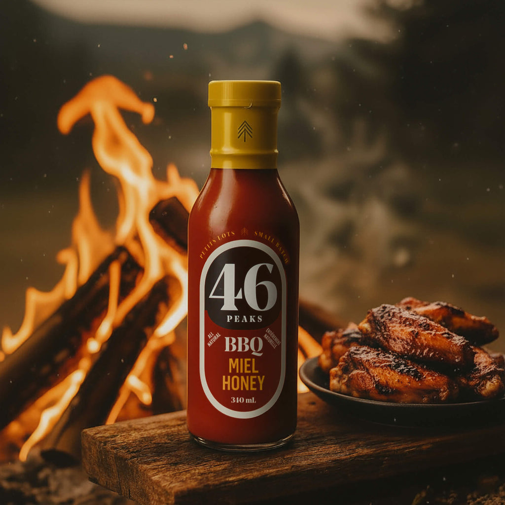 Bottle of 46 Peaks BBQ Miel Honey sauce with grilled chicken in front of a campfire