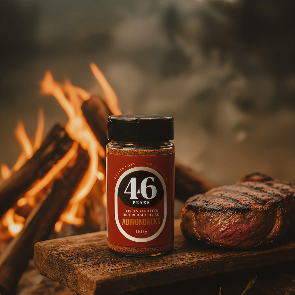 46 Peaks seasoning jar with a campfire and grilled steak in the background